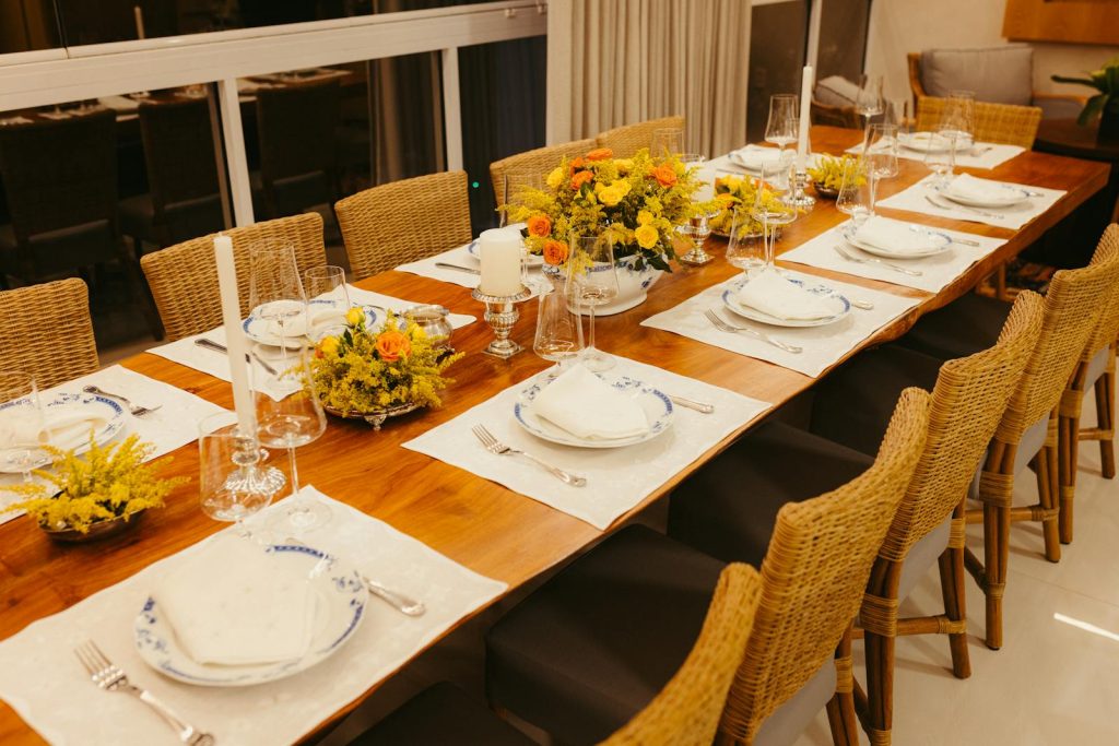 Beautifully set dining table with floral arrangements, perfect for a dinner party.